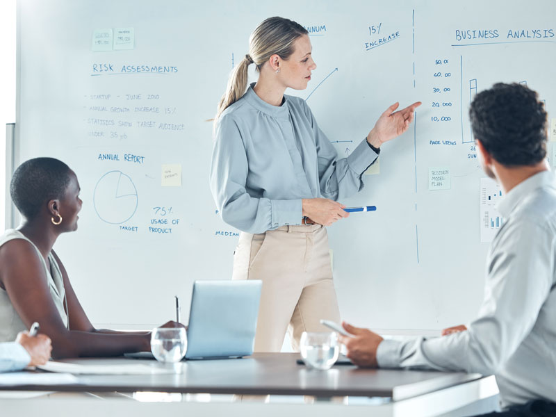 people looking at whiteboard for information