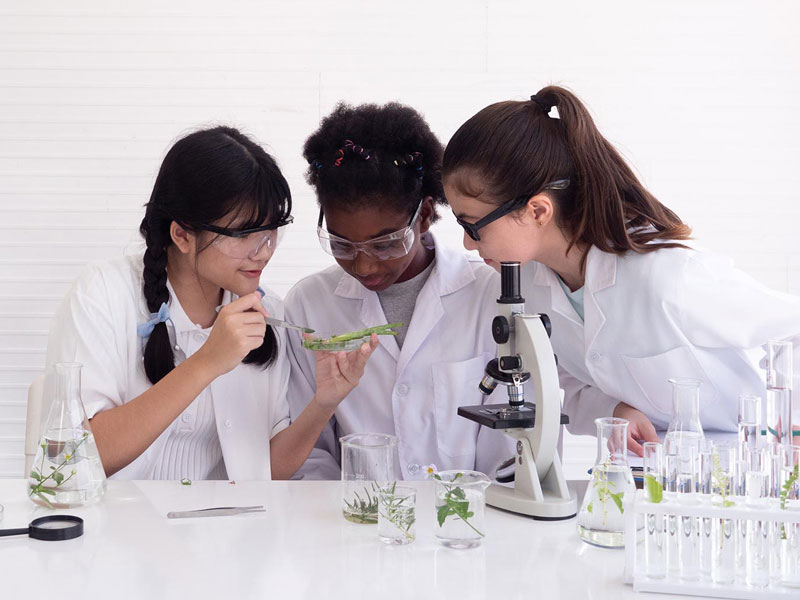 students with microscopes
