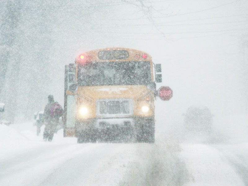 school bus picking up kids in snow